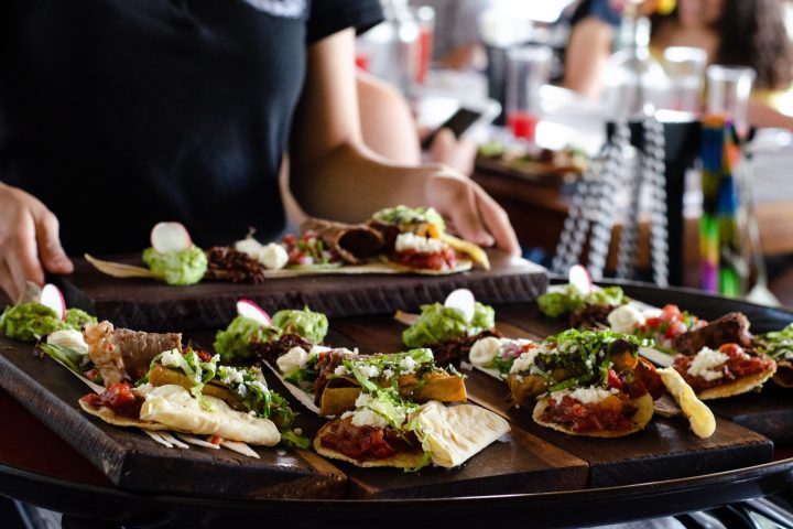 a person sitting at a table with a plate of food